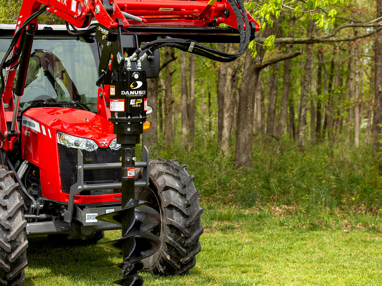 Image showing Danuser EP 1020 Auger Drive on Red Massey Ferguson tractor operating in a forested area