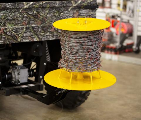 Image showing close-up of Danuser Python Wire Unroller on camo Bennche 4WD holding spool of barbed wire