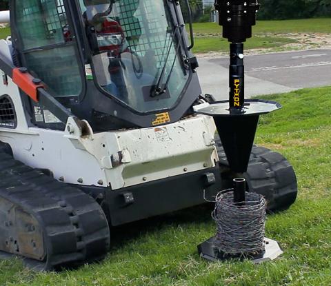 Image showing Danuser Python Wire Winder on Bobcat T870 beside grassy roadside with wire setup in progress