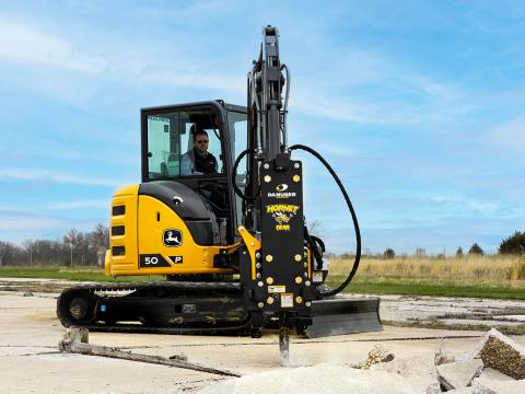 Image showing Danuser Hornet T8-RR post driver on Mini John Deere 50P Excavator breaking concrete outdoors near grassy site