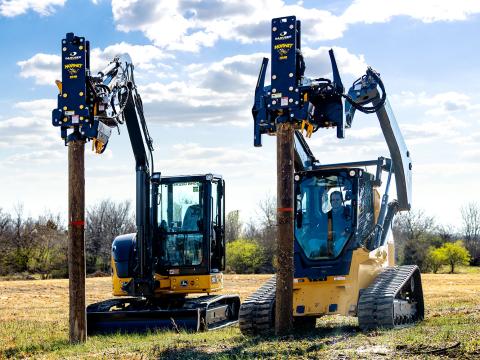 Image showing Danuser Hornet T8-RR post driver on a John Deere 333G Skid Steer and 50P Excavator holding posts in grassy field with trees in the background