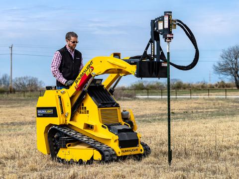 Image showing Danuser T3 post driver on BaumaLight TRL620D Mini Skid Steer driving a fence post into the ground in a field
