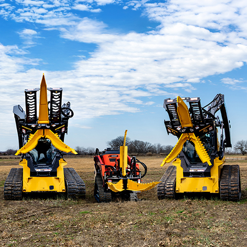 Intimidator, Intimidator CT, and Intimidator XL sitting next to each other in a field with their jaws open showing how powerful they are.